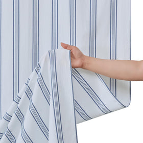 Lighting shows slight color variation on ORTIGIA curtain panels.