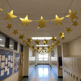Outus gold star cutouts used as table decor and wall accents.