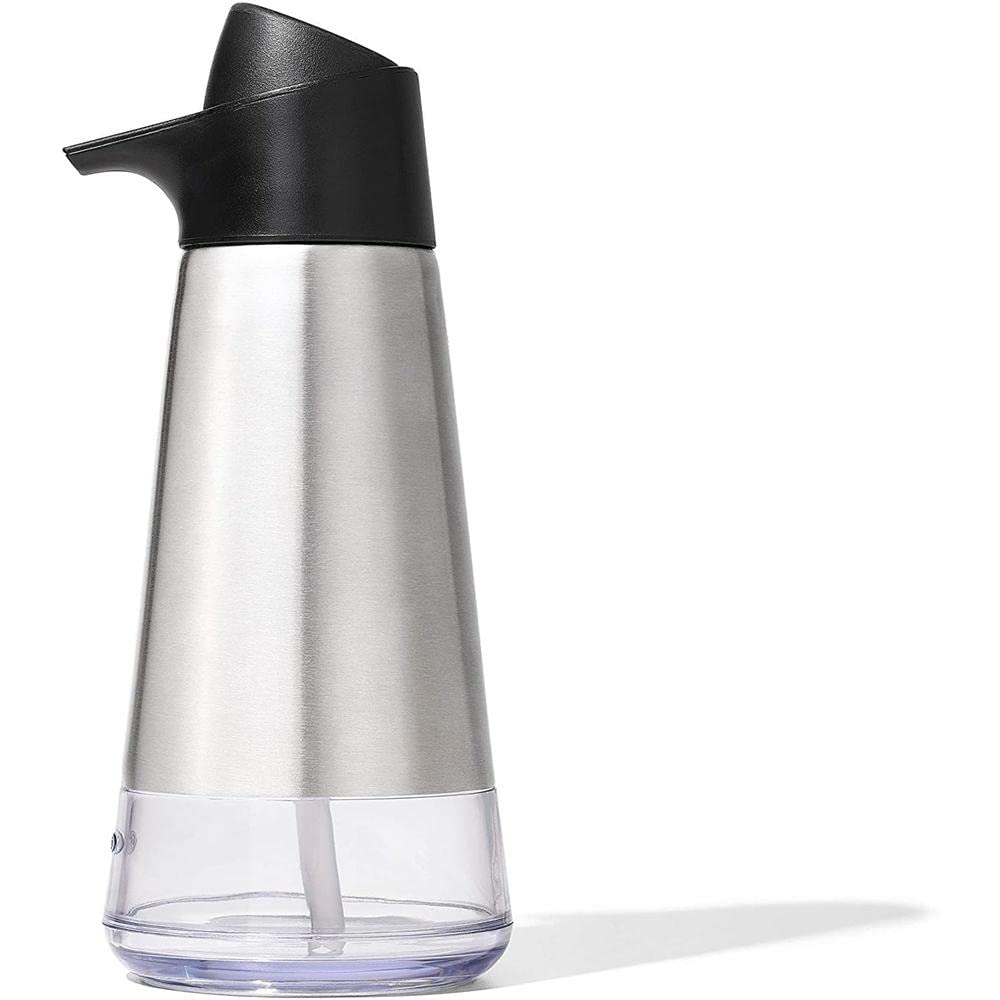 Spout close-up of the OXO dispenser showing precise dispensing onto a sponge