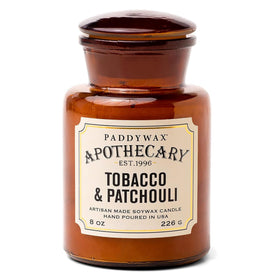 Paddywax Artisan Apothecary candle in reusable glass jar creates warm ambience.