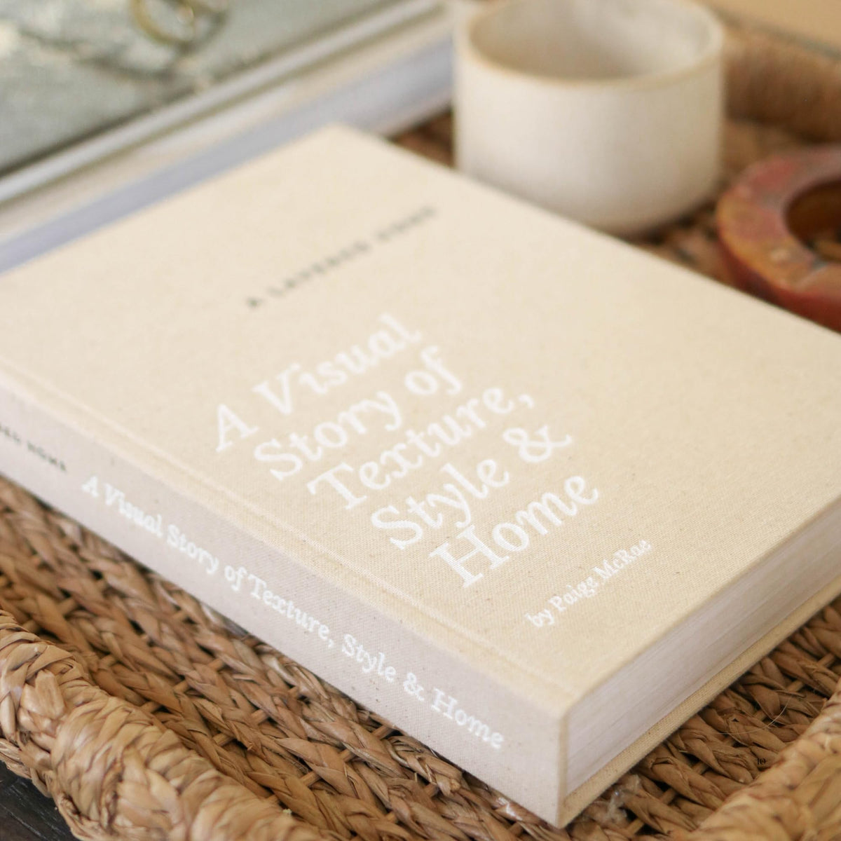 Paige McRae coffee table display setup with neutral-toned faux books