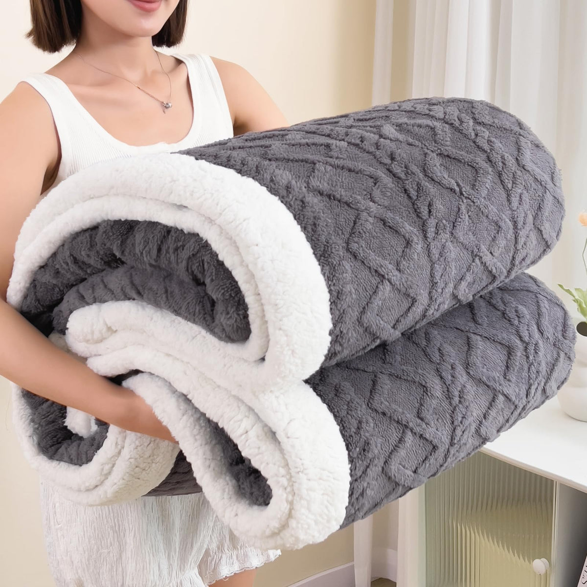 PAJEO Sherpa blanket shows double comfort for year-round coziness on bed or couch.