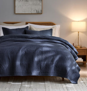 Palassio striped navy quilt on king bed highlighting lightweight cotton comfort