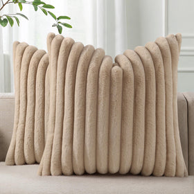 Pallene faux fur stripe pillow cover on sofa adds cozy texture.