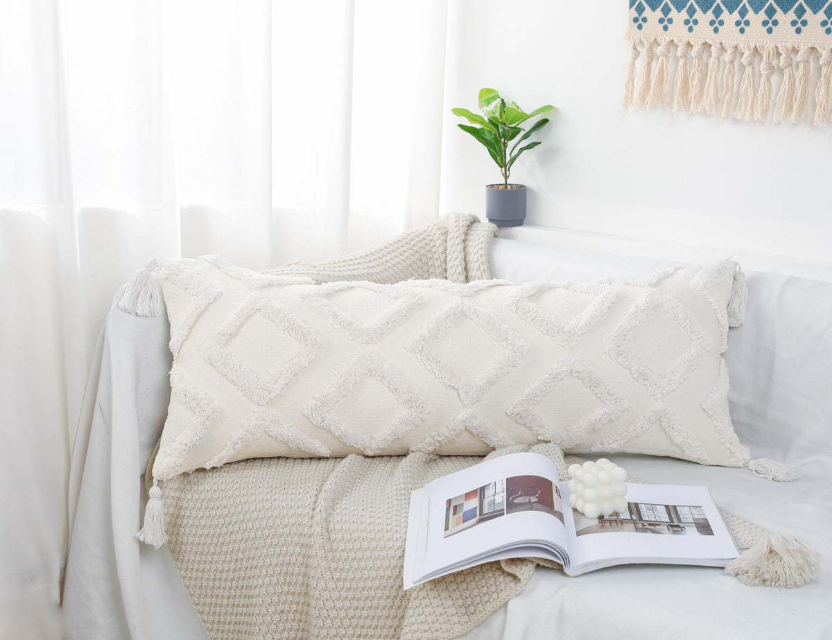PANOD pillow cover with tassel in boho style on bed.