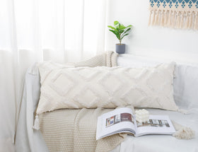 PANOD pillow cover with tassel in boho style on bed.