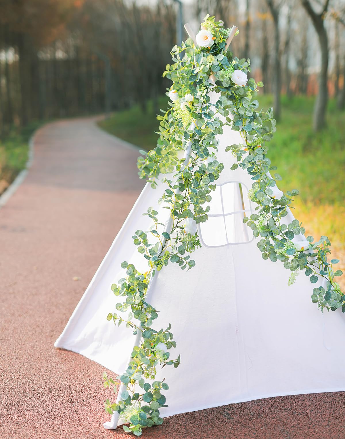 PARTY JOY garland arranged on a wedding arch backdrop