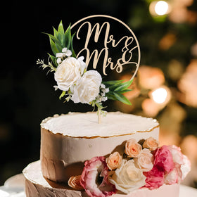 Party to Be close-up of 3D white roses on wooden cake topper.