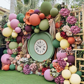 Partycus baby shower setup with a soft pastel arch.