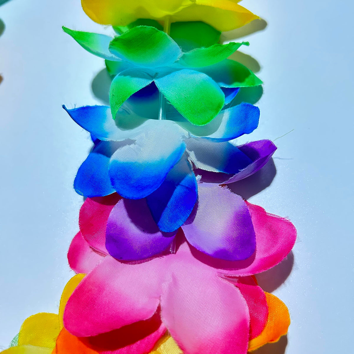 Patyflow 36-inch leis showcase vibrant tropical flowers for beach parties.