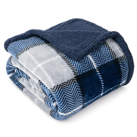PAVILIA blue navy plaid sherpa throw blanket on bed, showcasing plush warmth.