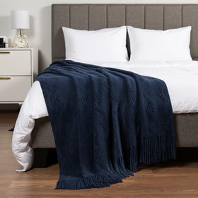 PAVILIA navy blue knit throw fringe tassels as decorative touch.