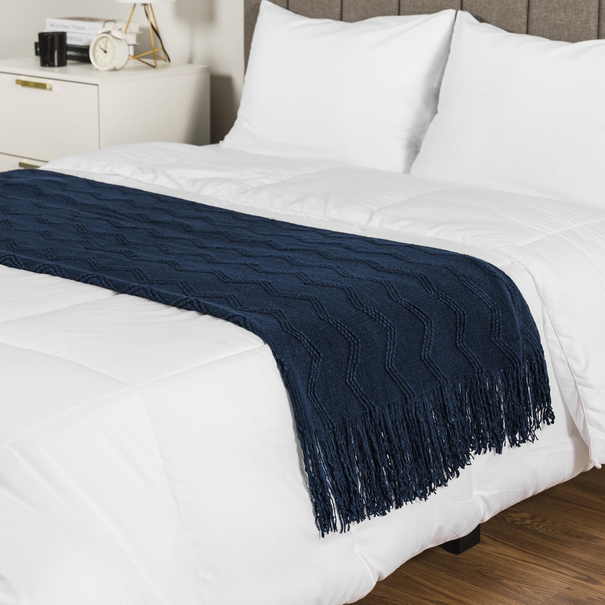 PAVILIA navy blue knit throw on living room chair for ambience.