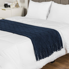 PAVILIA navy blue knit throw on living room chair for ambience.