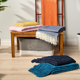 PAVILIA navy blue knit throw machine washable for easy care.