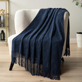 PAVILIA navy blue knit throw outdoors for light evening warmth.