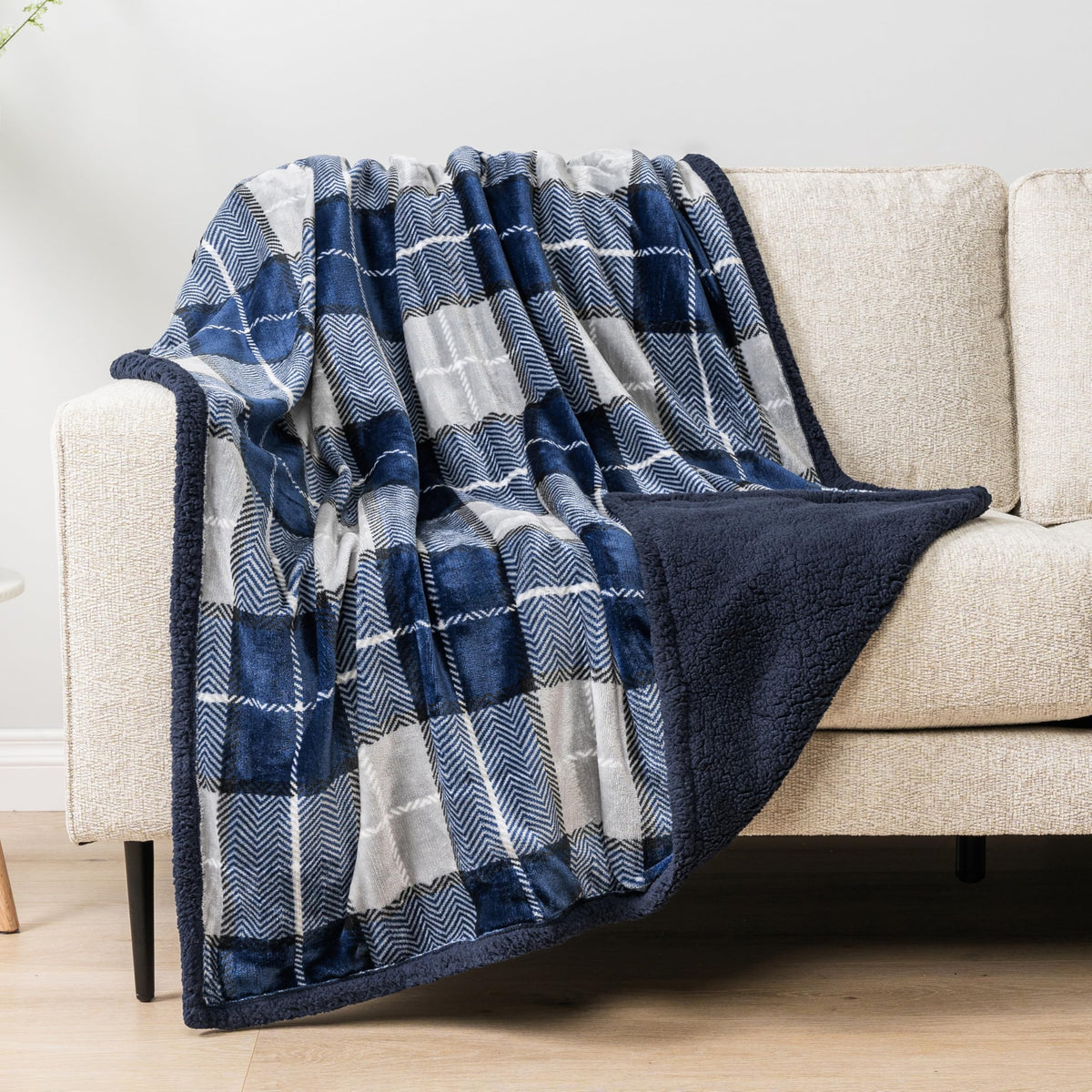 PAVILIA navy plaid decor draped over chair for cabin-style warmth.
