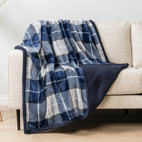 PAVILIA navy plaid decor draped over chair for cabin-style warmth.