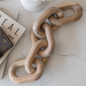 Peakoly acacia wood chain-link decor on a shelf adding warm texture to living spaces