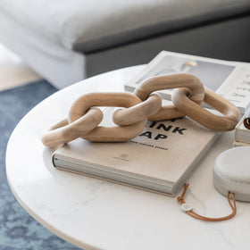 Peakoly acacia wood chain-link sculpture enhances minimalist coffee tables with organic lines