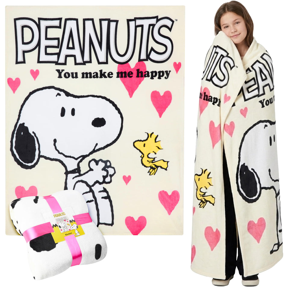 Peanuts Snoopy blanket on a couch showing soft fleece and cozy decor