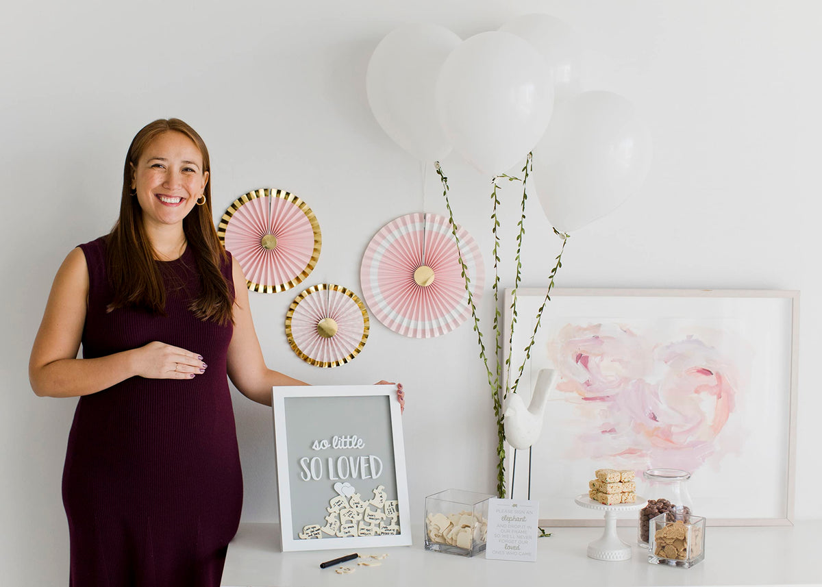 Neutral gray and white palette complements safari-themed nurseries with Pearhead design.
