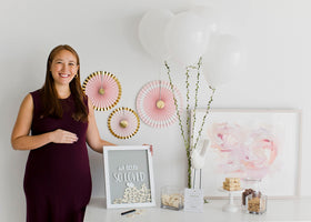 Neutral gray and white palette complements safari-themed nurseries with Pearhead design.