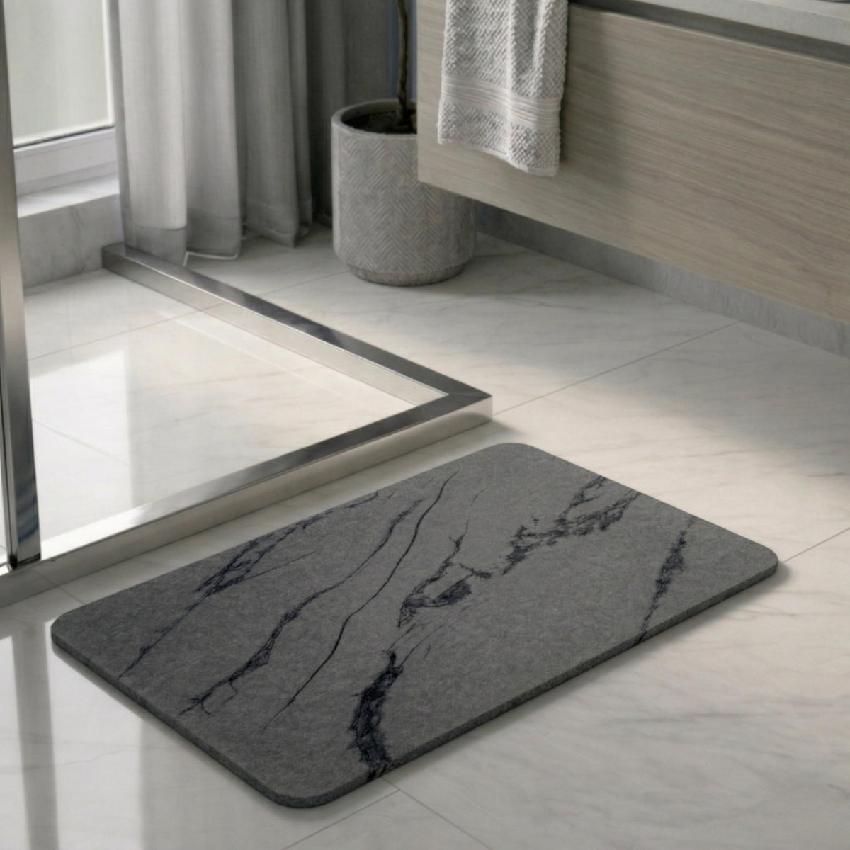 Pebble Nest stone bath mat charcoal dries quickly after showers.