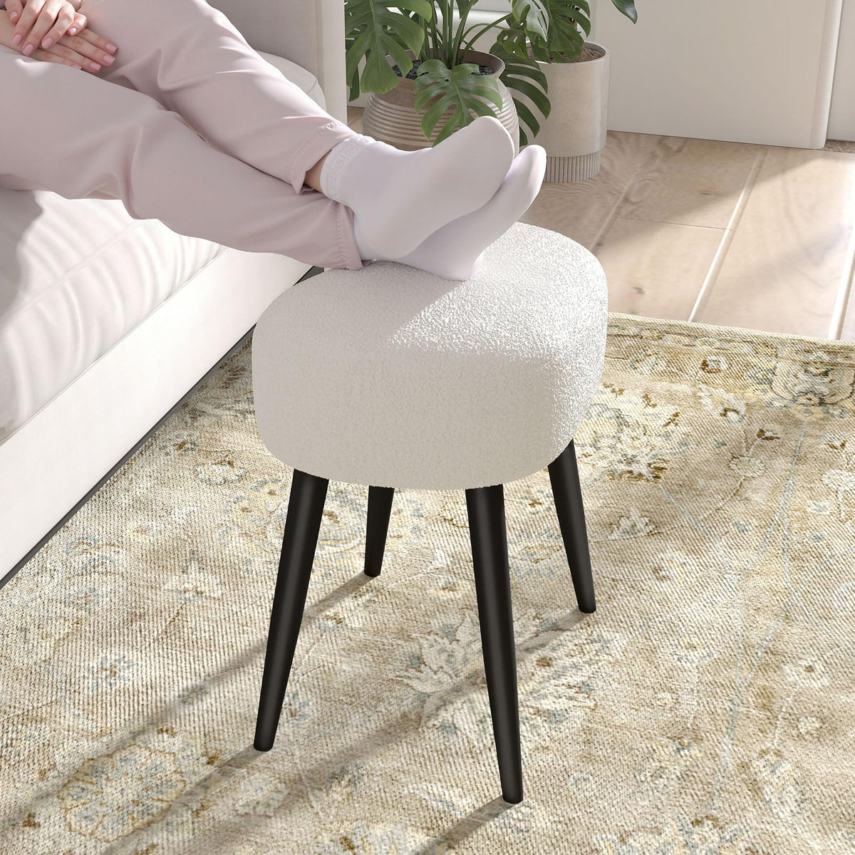 Versatile white vanity stool beside mirrors and desks in a room.