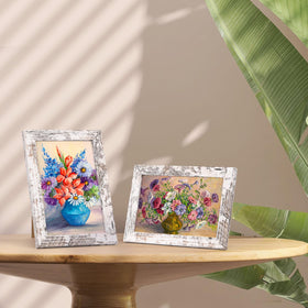 PETAFLOP wooden frames show distressed white finish and wood grain texture.