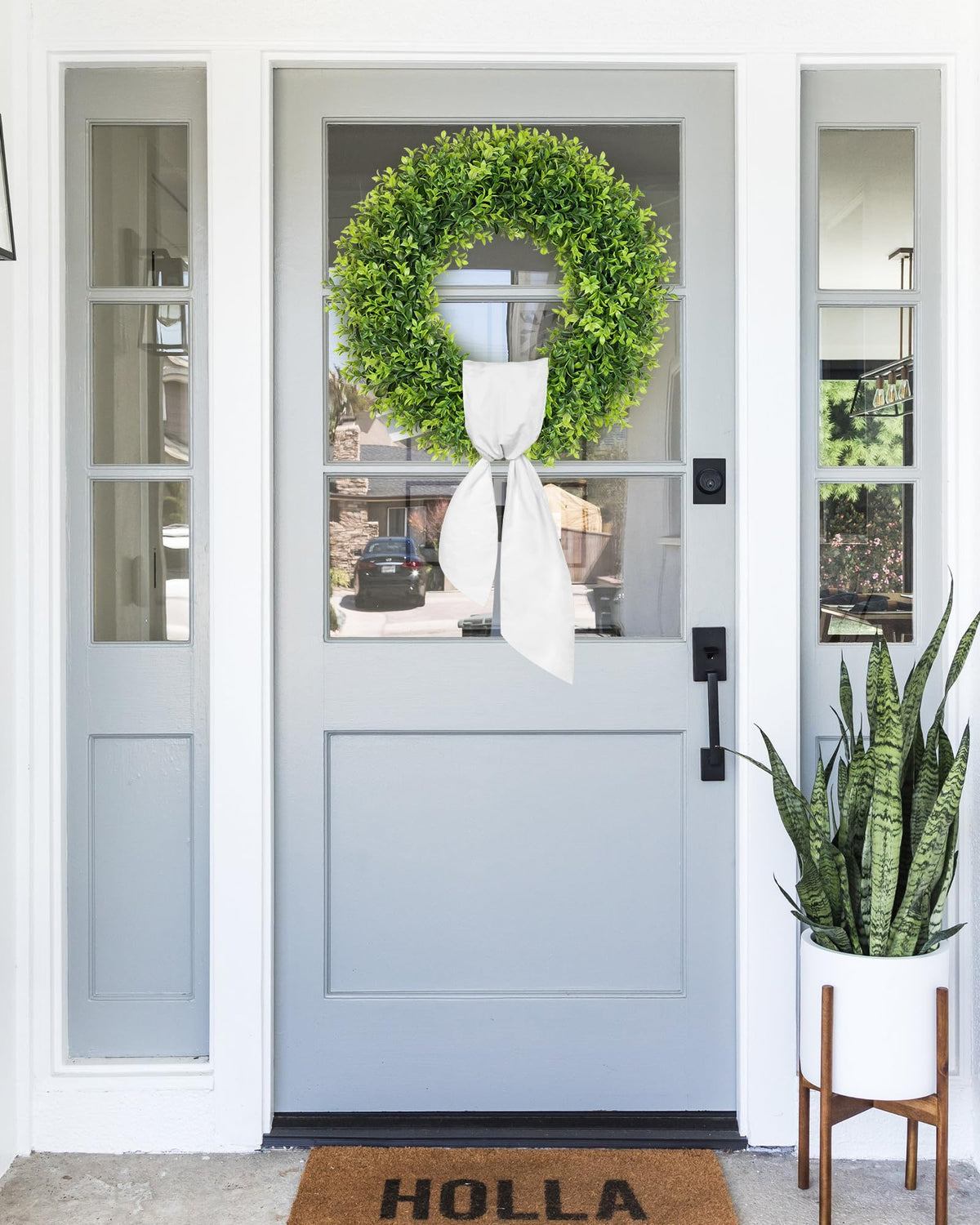 Petalyn boxwood wreath displayed on a fireplace mantel