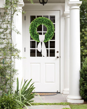 Petalyn boxwood wreath with white sash for a timeless look