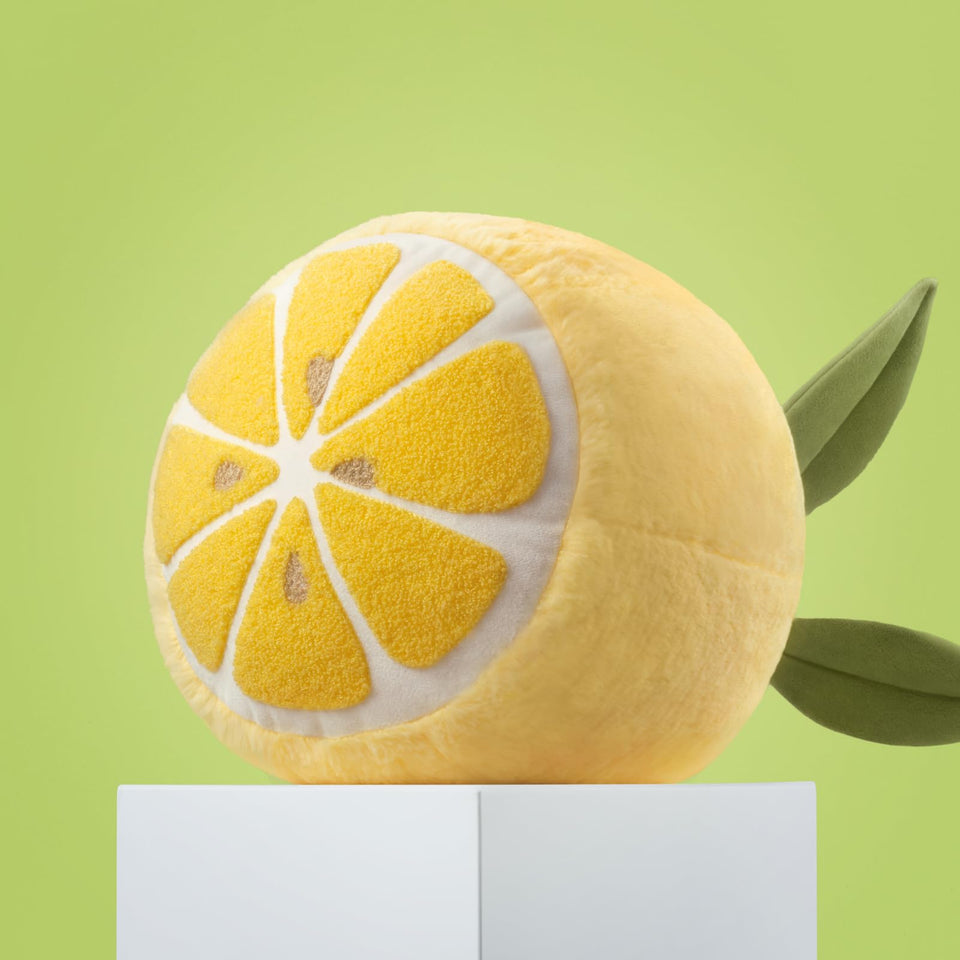 Phantoscope Lemon Shaped Throw Pillow front view adds cozy decor to a living room.