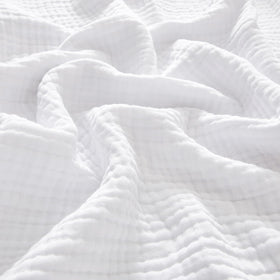 PHF cotton muslin blanket king size 108x90 on a bed, offering soft, breathable comfort.