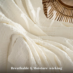 PHF cotton waffle blanket ivory folded-on-bed demonstrates compact storage and easy layering.