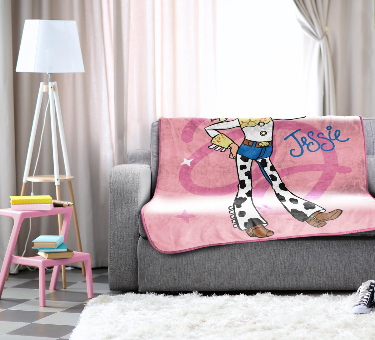 Pink decorative blanket adds playful charm to a child’s room