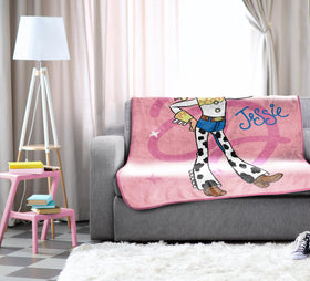 Pink decorative blanket adds playful charm to a child’s room