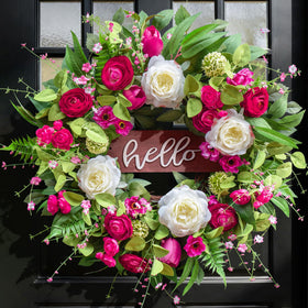 Pinkpuii Spring Wreath with Hello sign welcomes guests at the front door