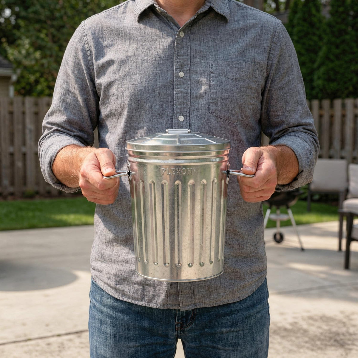 Plexon round metal trash bin with lid keeps bathroom odors contained.