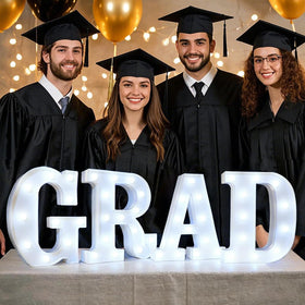 Pooqla GRAD LED letters on table decorate with steady warm light for celebrations.