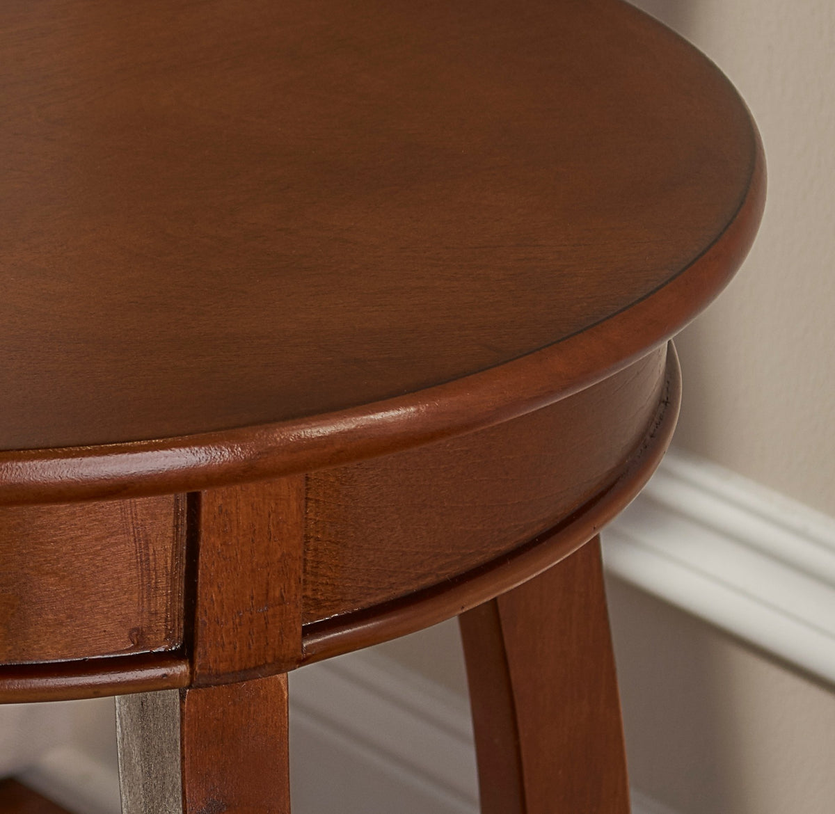 Powell Hazelnut round shelf table beside sofa as bedside substitute