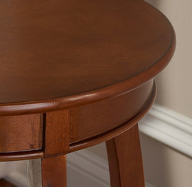 Powell Hazelnut round shelf table beside sofa as bedside substitute