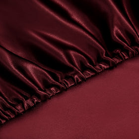 P Pothuiny burgundy satin bedding in a styled bedroom