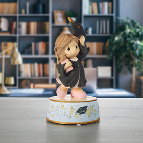 Precious Moments brunette graduate in black gown is a timeless keepsake.