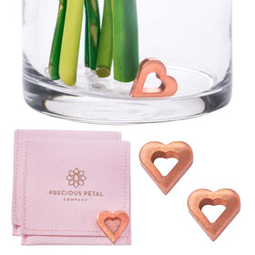 Precious Petal Co copper charm in a small vase keeps water clean