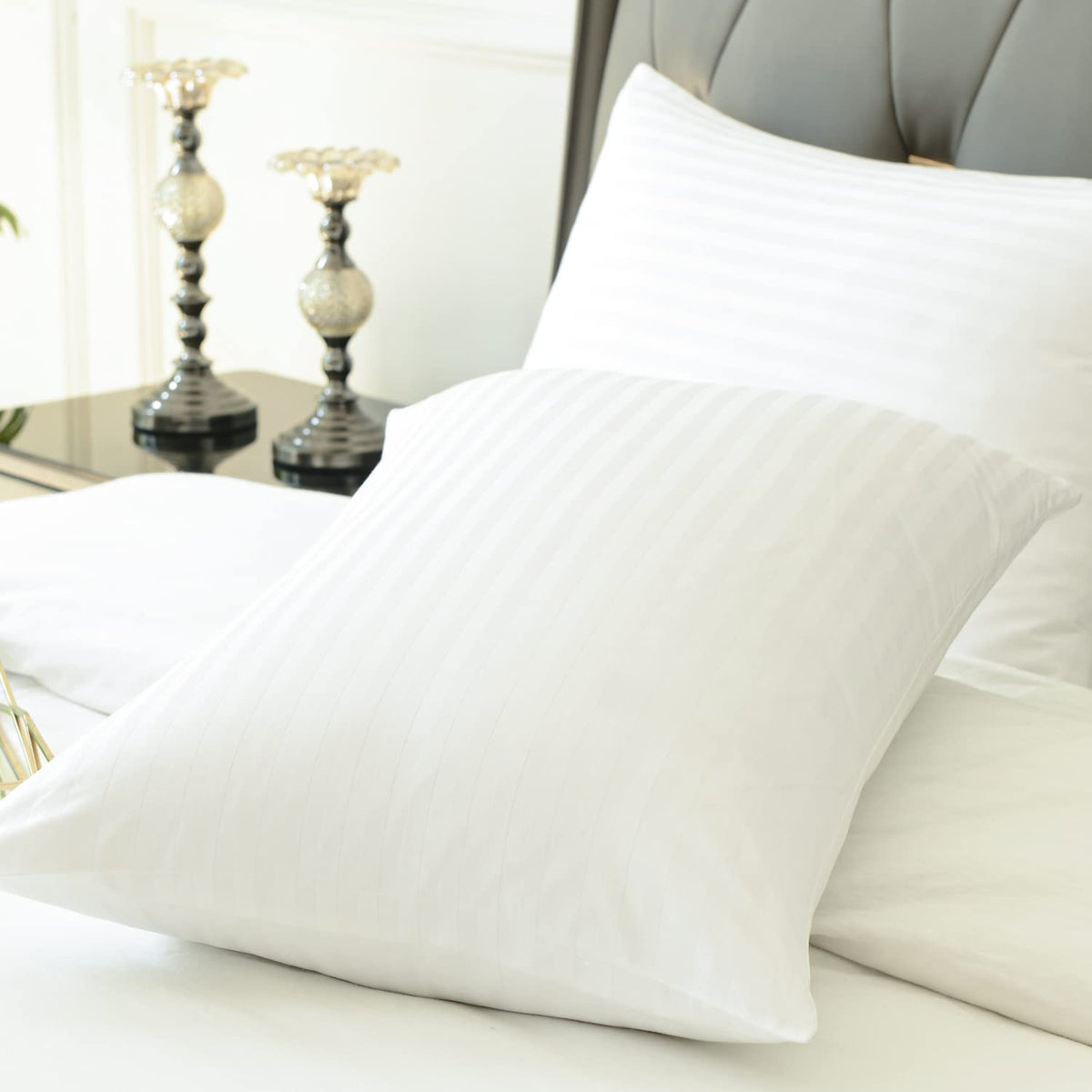 Precoco pillow protectors four-pack white stacked for easy replacement