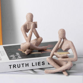 Prettidecor Reading Thinker Statue with book enhances shelf display.