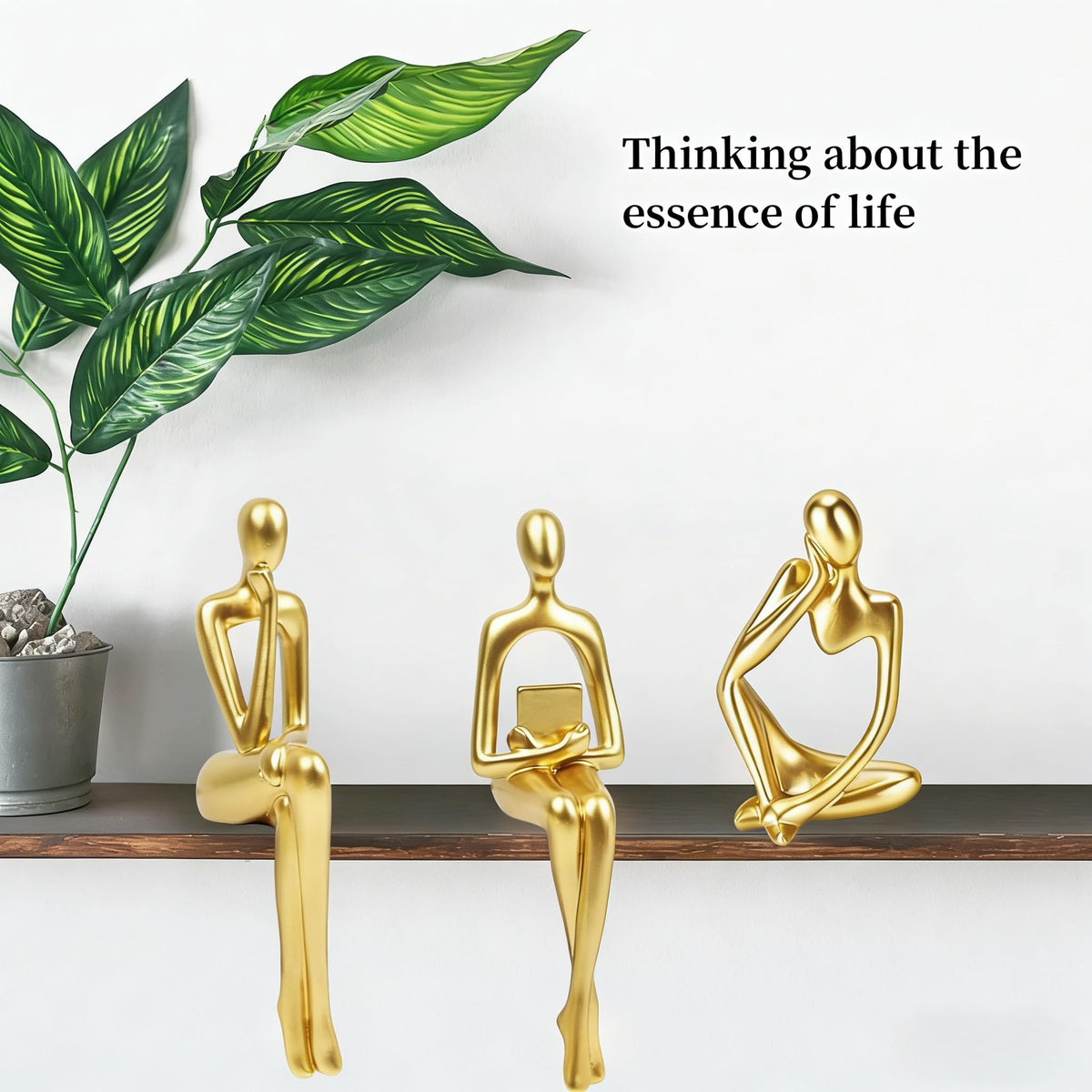 Prettidecor gold thinker trio on mantel adds elegance