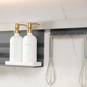 Prus Waso Gold hand and dish tray close-up highlights anti-slip stability.