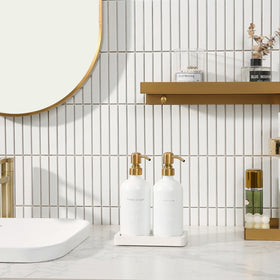 Prus Waso gold lotion dispenser beside soap creates a coordinated bathroom look.